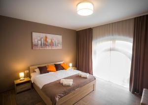 a bedroom with a bed with two towels on it at Centar lux 2 in Zrenjanin