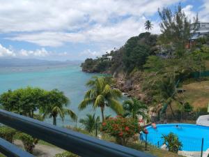 Una vista del océano desde el balcón de un resort. en Studio AQUA à GOSIER, en Le Gosier