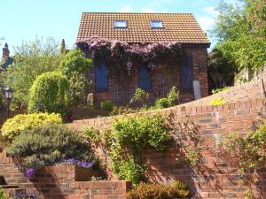 una casa de ladrillo con flores en una pared de ladrillo en Big Sky Guest House- ROOM ONLY, en Whitby