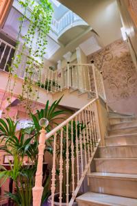 a spiral staircase in a building with plants at The Town House - Adults Only in Marbella