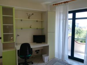 a room with a desk with a computer and a window at La Collina Capo d'Orlando in Capo dʼOrlando