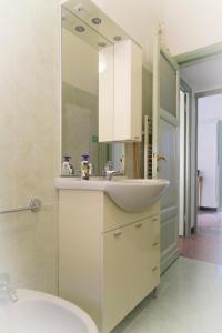 a white bathroom with a sink and a toilet at Verde Monte Di Portofino by PortofinoVacanze in Rapallo