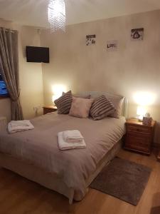 a bedroom with a bed with two towels on it at Rockhill hospitality in Coleraine