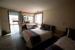 Postel nebo postele na pokoji v ubytování Hotel Helverica