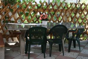 a table with four chairs and a glass top at Camping Victoria in Capaccio-Paestum