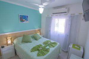 Cama ou camas em um quarto em Pousada Irashai