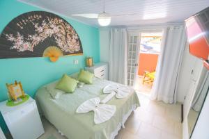 Cama ou camas em um quarto em Pousada Irashai