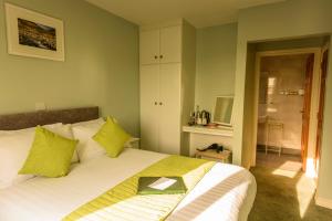 a bedroom with a bed with a book on it at The Pipers Rest in Doolin