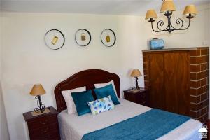 מיטה או מיטות בחדר ב-Casa do Beco