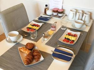 a table with breakfast foods and coffee on it at The Lilac Door in London