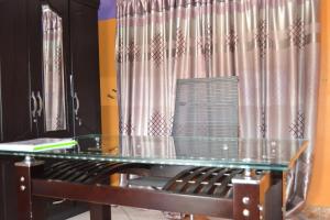 a glass table in front of a curtain at Seelo Guest Accommodation in Letlhakawe