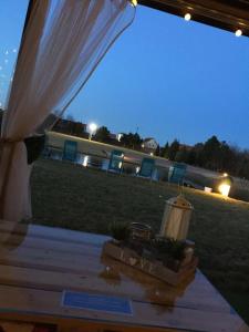 a marquee with a white curtain and chairs in a field at Comfort Zone Ostróda Apartment 1 in Grabinek