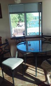 a glass table and a chair and a window at Overlooking clearlake from the living room in Clearlake +15 photos