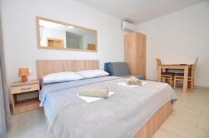 a bedroom with a large bed with a mirror at Apartments Valentino in Gradac