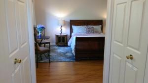 a bedroom with a bed and a table with a chair at HB Guest Home 5 in Waterloo