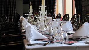 a table with white napkins and glasses on it at Loch Ness Lodge Hotel in Drumnadrochit