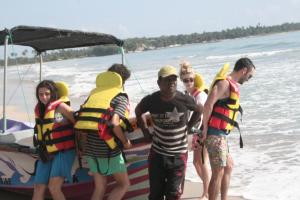 a group of people on a boat on the beach at So-J Beach Villa in Trincomalee