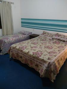 two beds sitting in a room with a window at Suíte Bella Vista in Barra Grande