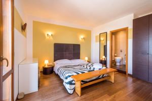 a bedroom with a bed and a table and a sink at B&B Le Dune - Self Check in in Lascari