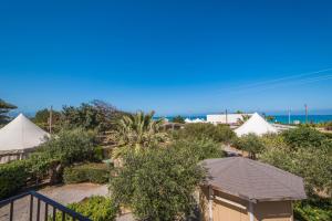 a view of a resort with tents and trees at B&B Le Dune - Self Check in in Lascari