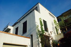 a white building with windows on the side of it at N1 Standalone House Baden in Hertenstein