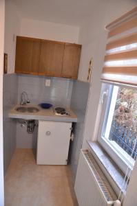 a small kitchen with a sink and a window at Domaćinstvo Una-Ostrovica in Kulen Vakuf