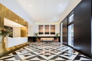 a lobby with a black and white tiled floor at The Lumiares Hotel & Spa - Small Luxury Hotels Of The World in Lisbon