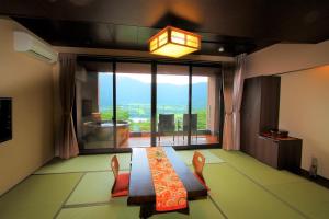 a dining room with a table and chairs and a large window at Hakone Hoshi no Akari in Hakone