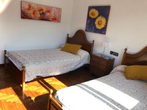 Postel nebo postele na pokoji v ubytování Hogar Pepa