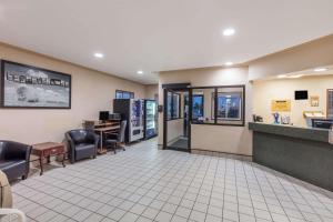 a waiting room at a hospital with chairs and a counter at Super 8 by Wyndham Moose Jaw SK in Moose Jaw