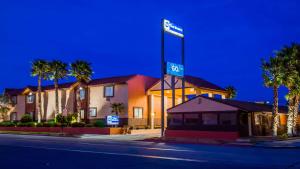 a hotel with a sign on top of a building at Best Western Desert Winds in Mojave