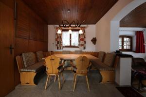 a dining room with a wooden table and chairs at Voa Crestas 7 (715 He) in Sporz
