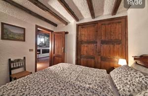 a bedroom with a bed and a wooden door at Villa dei Rosmarini in Toscolano Maderno