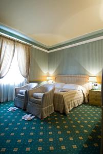 Postel nebo postele na pokoji v ubytování Grand Hotel Nizza Et Suisse