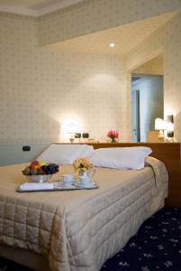 Postel nebo postele na pokoji v ubytování Grand Hotel Nizza Et Suisse