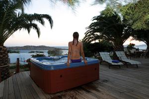 a man sitting in a bath tub on a deck at Zephyros in Paraga