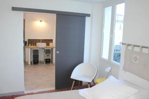 a bedroom with a door leading to a bathroom at La maison de jules in Moustiers-Sainte-Marie