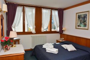 Posteľ alebo postele v izbe v ubytovaní Ski Residence
