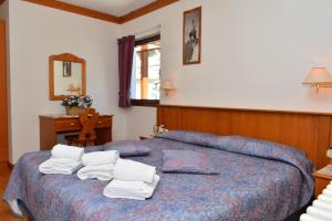 Posteľ alebo postele v izbe v ubytovaní Ski Residence