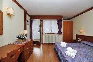 Posteľ alebo postele v izbe v ubytovaní Ski Residence