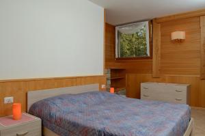 Posteľ alebo postele v izbe v ubytovaní Ski Residence