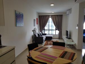 a living room with a table and a couch at Eclipse Residence Pangea in Cyberjaya