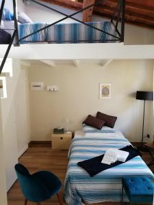 a bedroom with a bed with a blue chair at Casa Allegri in Florence