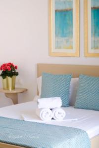 Una cama con dos toallas encima. en River Side Hotel, en Georgioupolis