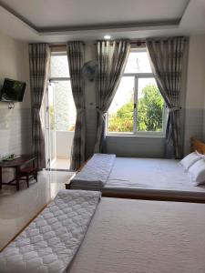 Tempat tidur dalam kamar di Nguyễn Kim Motel