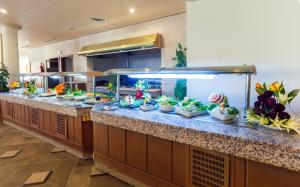 a buffet line with fish tanks in a restaurant at El Mouradi Tozeur in Tozeur