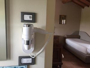 a phone on a wall next to a room with a bed at Corte Motte in Pegognaga