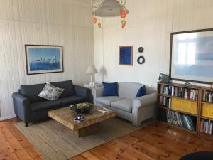 a living room with a couch and a table at The Secret Garden Guesthouse in Swakopmund