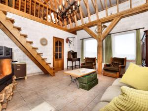 a living room with a couch and a table at Holiday home in peaceful setting and large garden in Rendeux