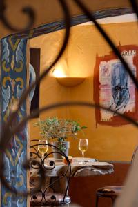 a table with two glasses of wine on it at La Tramontane in Saintes-Maries-de-la-Mer